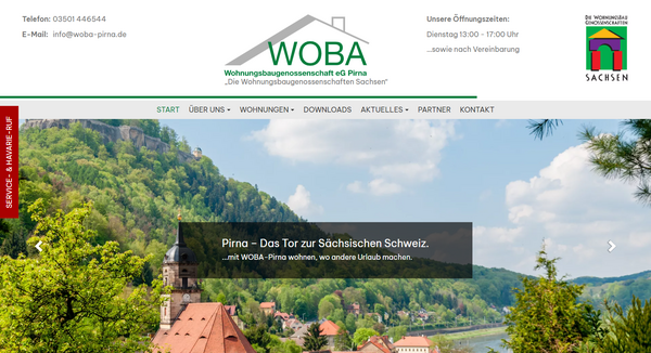 Notebook-Ansicht der Woba-Pirna.de Website mit Übersicht der Wohnungsangebote